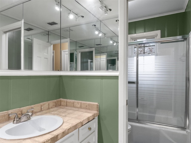 full bathroom with vanity, shower / bath combination with glass door, and toilet