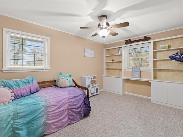 bedroom with multiple windows, crown molding, carpet flooring, and built in desk