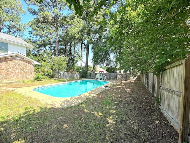 view of pool with a yard