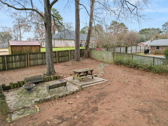 view of yard with a patio area and an outdoor fire pit