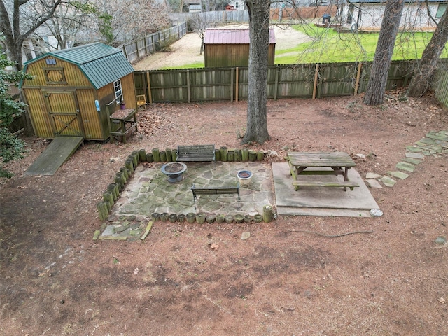 view of yard featuring a patio area and a shed