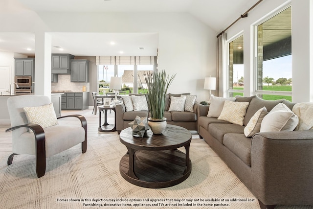 living room with vaulted ceiling and sink