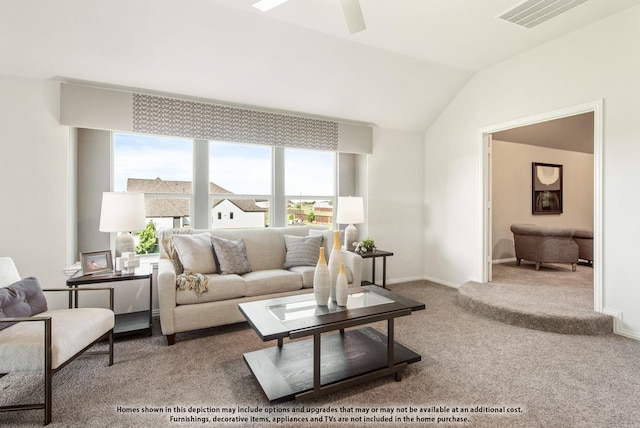 carpeted living room featuring vaulted ceiling