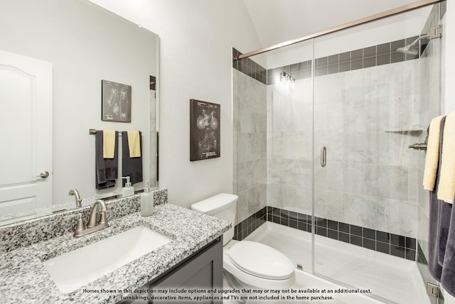 bathroom with vanity, an enclosed shower, and toilet