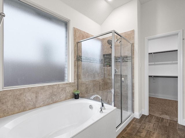 bathroom with independent shower and bath and vaulted ceiling