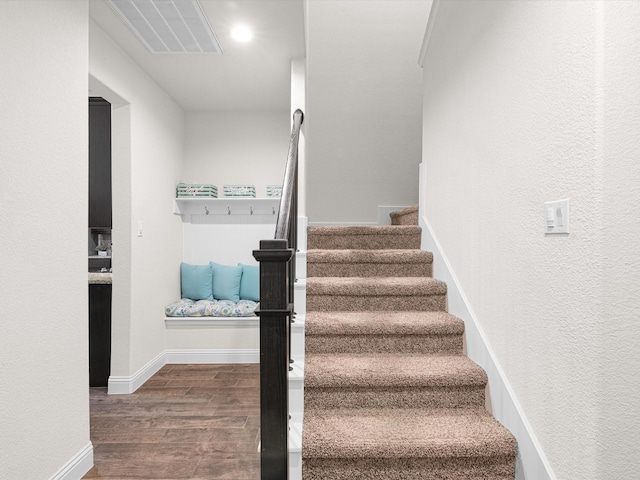 stairway with hardwood / wood-style floors