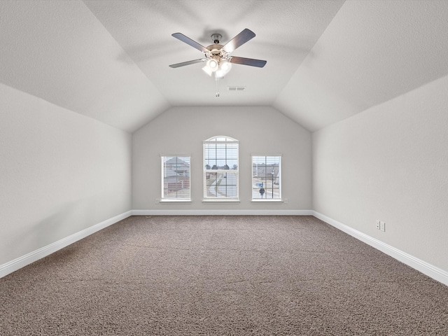 additional living space featuring vaulted ceiling, carpet flooring, and ceiling fan