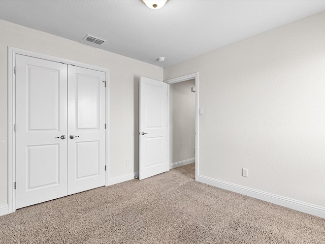 unfurnished bedroom with a closet and carpet