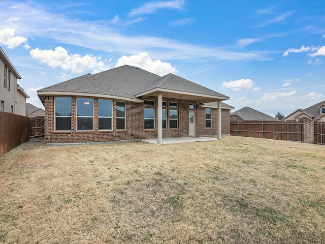 back of property featuring a patio and a yard