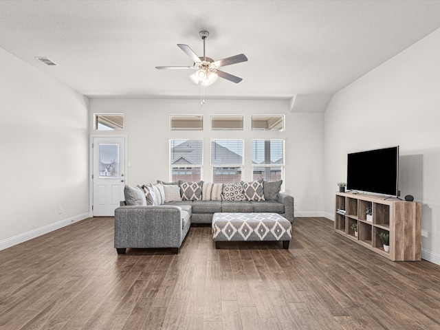 living room with vaulted ceiling, dark wood-type flooring, and ceiling fan