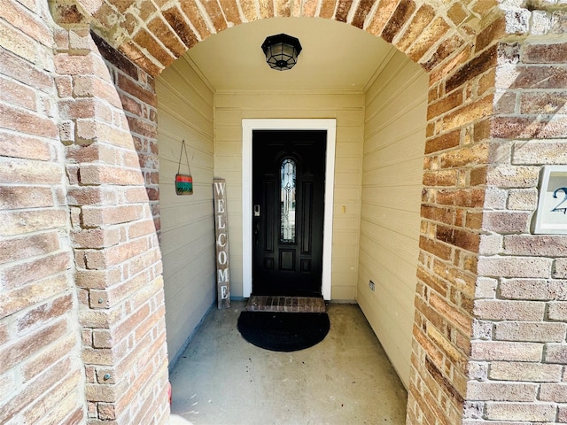 property entrance with brick siding