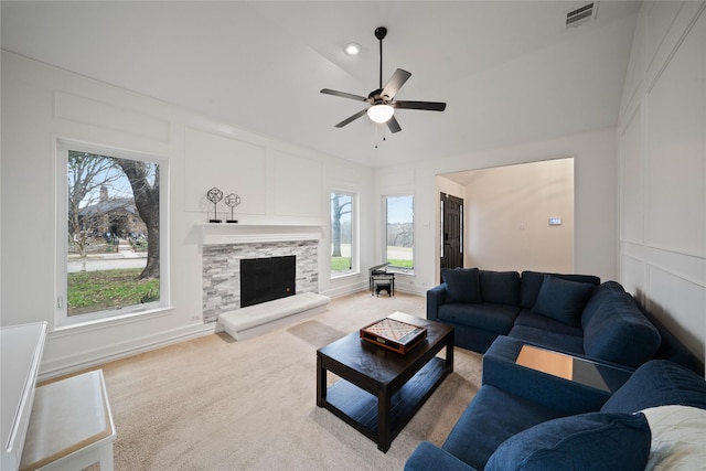 carpeted living room featuring ceiling fan and plenty of natural light