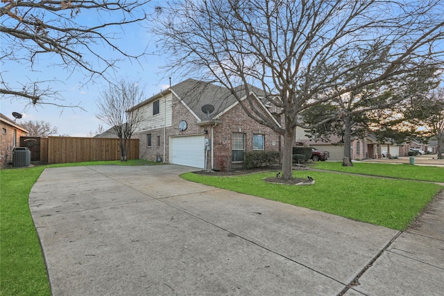 view of front of home featuring central AC, a garage, and a front yard