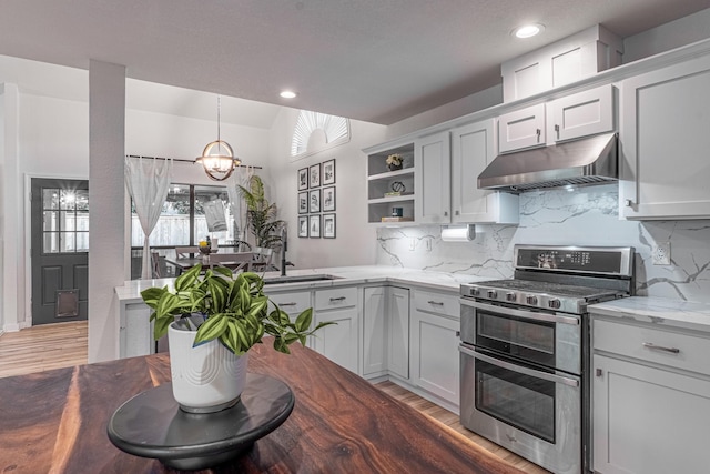 kitchen featuring under cabinet range hood, decorative backsplash, double oven range, and open shelves