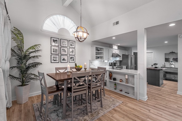 dining area featuring visible vents, beam ceiling, recessed lighting, light wood-style floors, and a notable chandelier