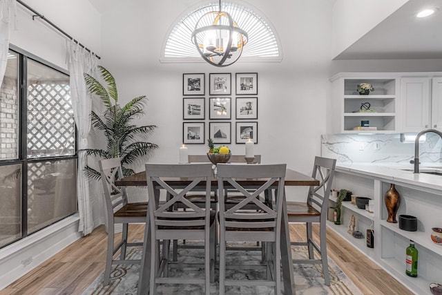 dining space featuring a chandelier and light wood-style flooring