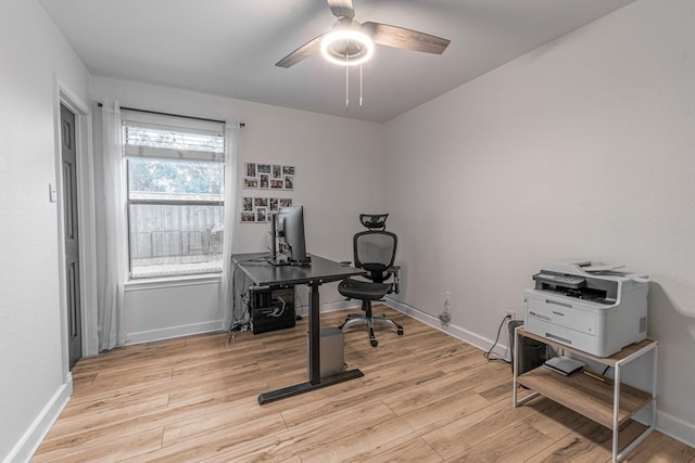 home office with baseboards, light wood-style flooring, and a ceiling fan