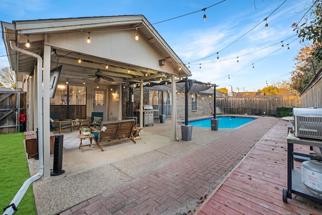 view of pool featuring a fenced in pool, a ceiling fan, a fenced backyard, a deck, and outdoor lounge area