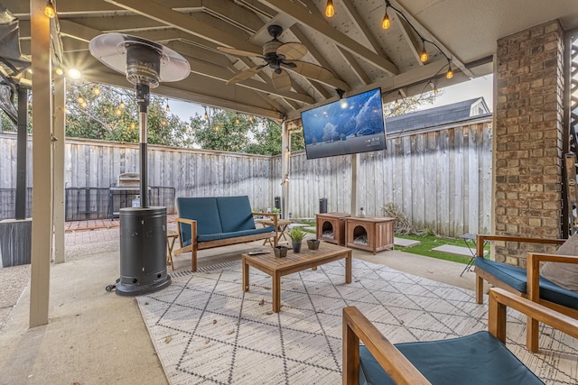 view of patio / terrace featuring an outdoor hangout area, a fenced backyard, and a ceiling fan