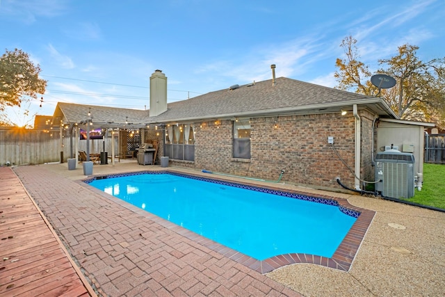 view of swimming pool with a patio, fence, a fenced in pool, area for grilling, and central air condition unit