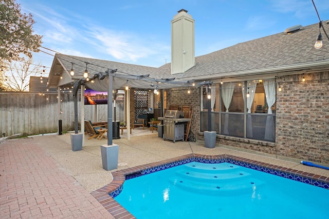 view of swimming pool with a patio, area for grilling, fence, and a pergola