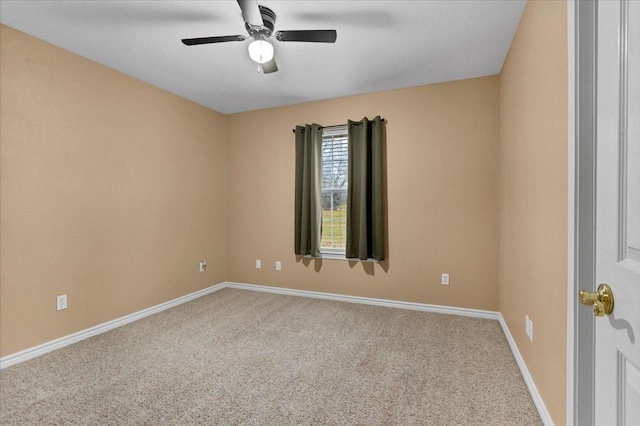 unfurnished room with baseboards, carpet floors, and a ceiling fan