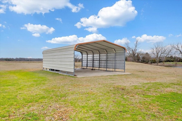 view of outbuilding with driveway and a detached carport