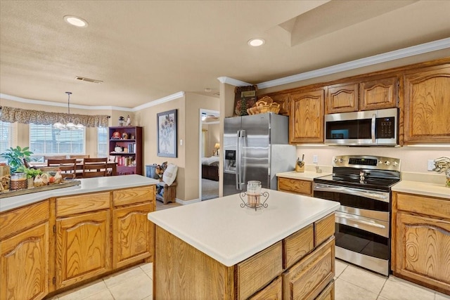 kitchen with light countertops, a chandelier, appliances with stainless steel finishes, brown cabinetry, and light tile patterned floors