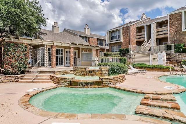 view of pool featuring a patio and pool water feature