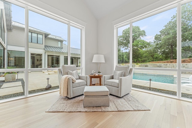 sunroom / solarium featuring lofted ceiling and a wealth of natural light