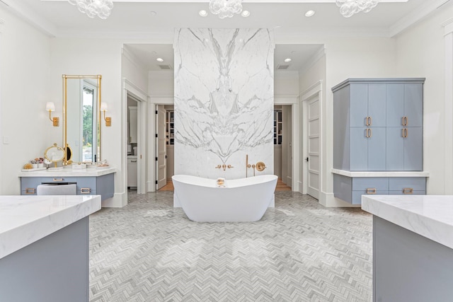 bathroom featuring vanity, a bath, and ornamental molding