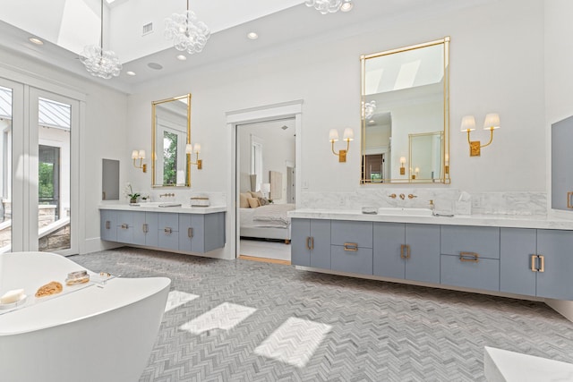 bathroom with an inviting chandelier and vanity