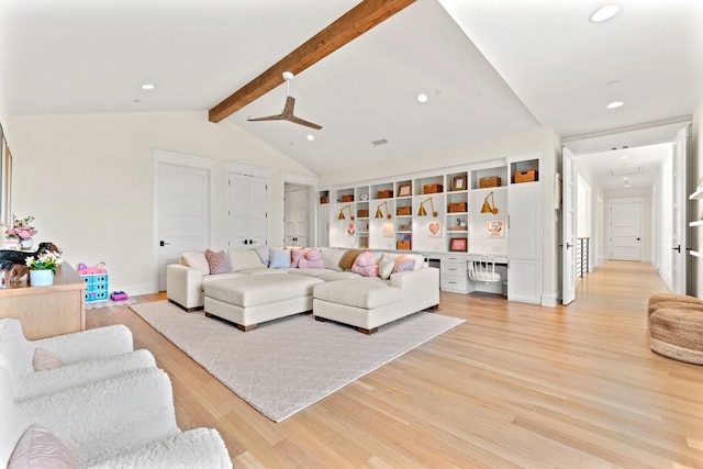 living room featuring light hardwood / wood-style flooring and lofted ceiling with beams