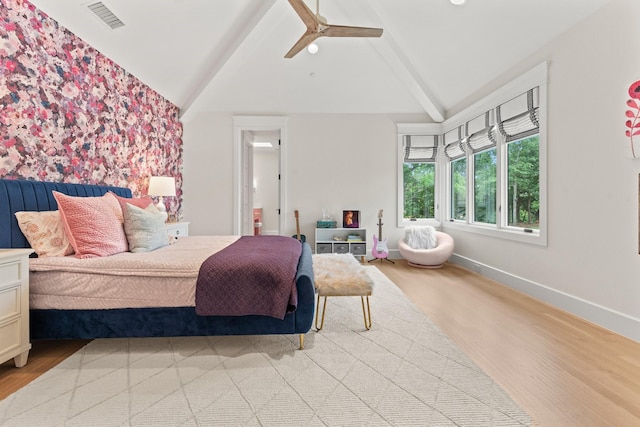 bedroom featuring vaulted ceiling with beams, light hardwood / wood-style flooring, and ceiling fan