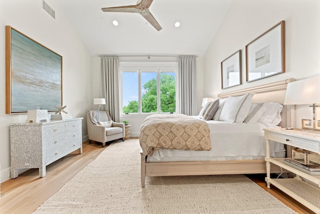 bedroom featuring lofted ceiling, ceiling fan, and light wood-type flooring