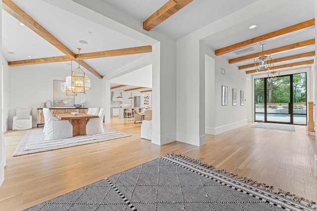 interior space with beamed ceiling, an inviting chandelier, and light hardwood / wood-style floors