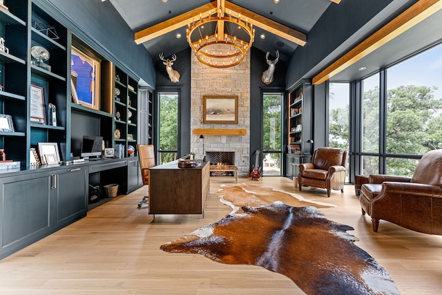 home office with high vaulted ceiling, a fireplace, beamed ceiling, a notable chandelier, and light wood-type flooring