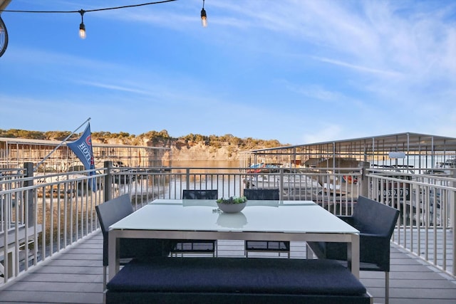 wooden terrace featuring a water view