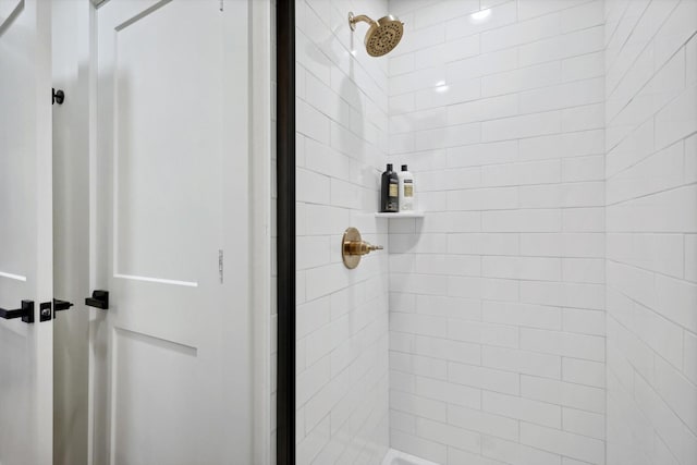 bathroom with a tile shower