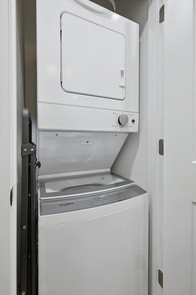 washroom featuring stacked washer and dryer