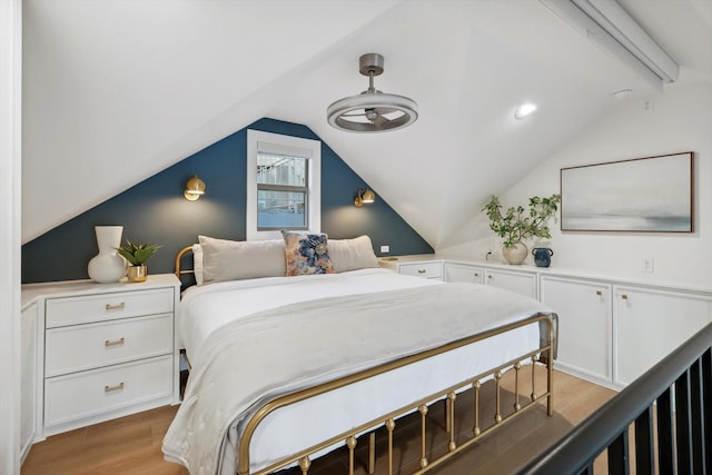 bedroom featuring wood-type flooring and vaulted ceiling with beams