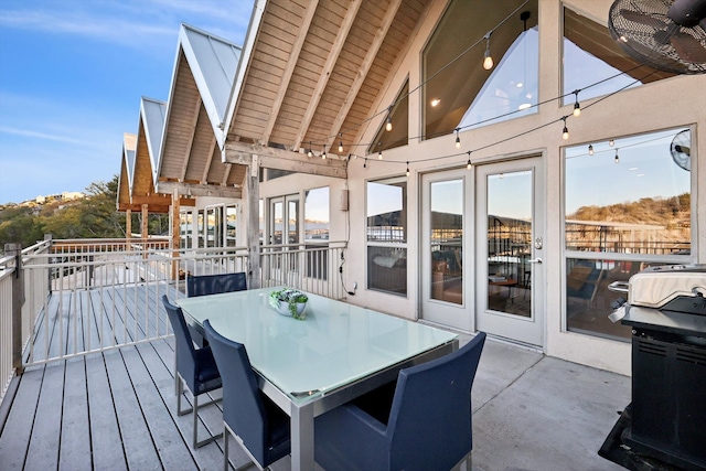 wooden deck with area for grilling and ceiling fan