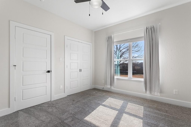 unfurnished bedroom featuring ceiling fan, carpet flooring, and a closet