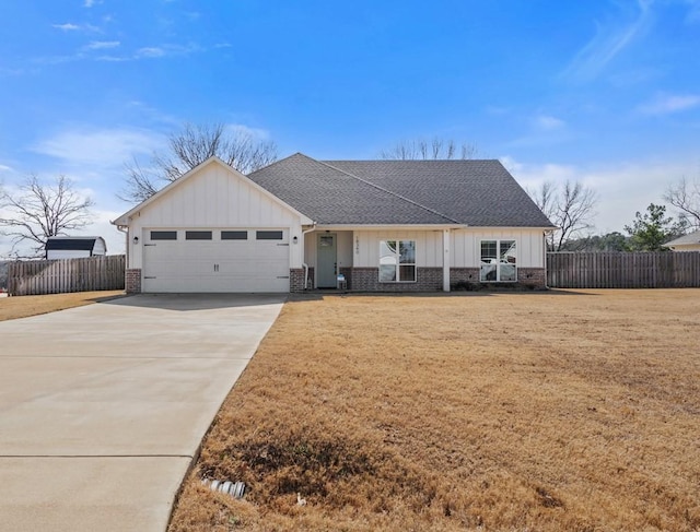 single story home featuring a garage and a front lawn