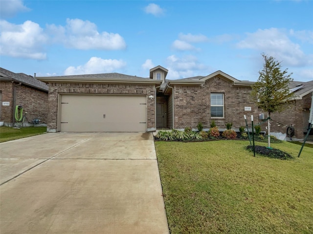 view of front of property featuring a garage and a front lawn