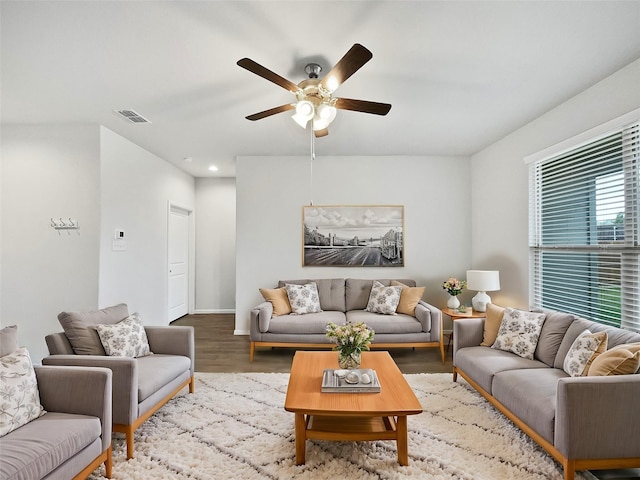 living room with wood-type flooring and ceiling fan