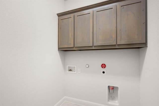laundry area with cabinet space, baseboards, hookup for a gas dryer, hookup for a washing machine, and electric dryer hookup
