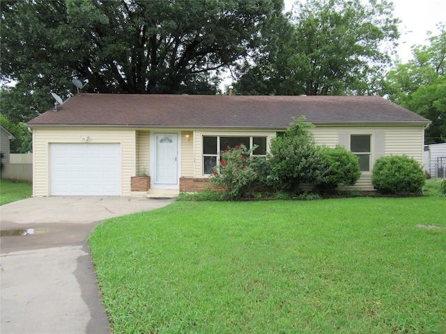 ranch-style home featuring a garage and a front yard