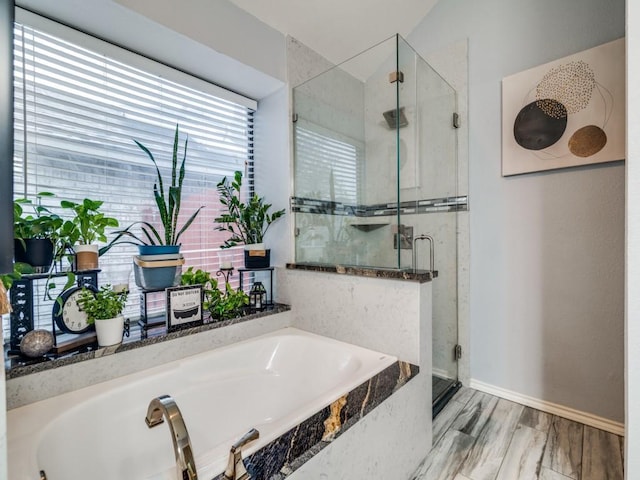 bathroom featuring plus walk in shower and hardwood / wood-style floors