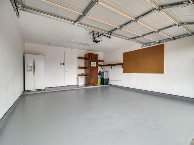 garage featuring a garage door opener and white refrigerator with ice dispenser